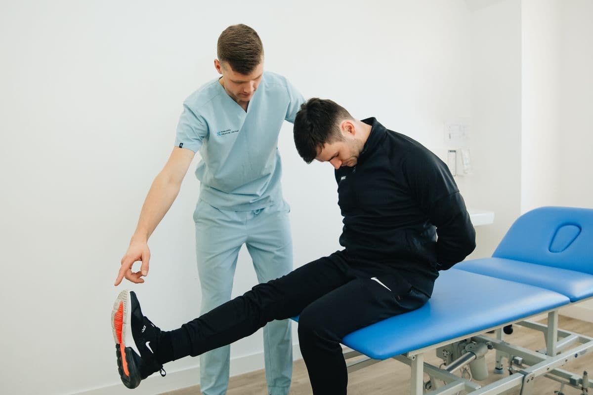 Physiotherapist instructing a client through a rehabilitation exercise